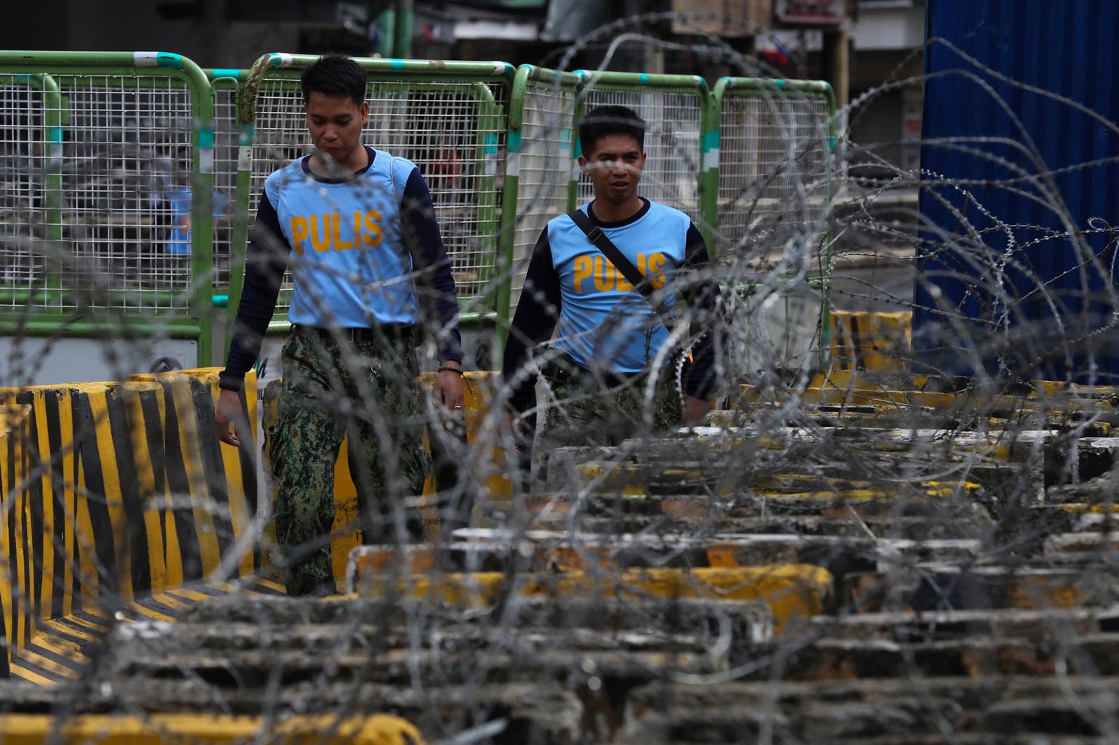 Concrete barriers, razor wire, and container vans block roads leading to the Malacañang Complex in Manila on 10 July 2026 as authorities tighten security ahead of an anti-corruption protest at Liwasang Bonifacio organized by an interfaith group.