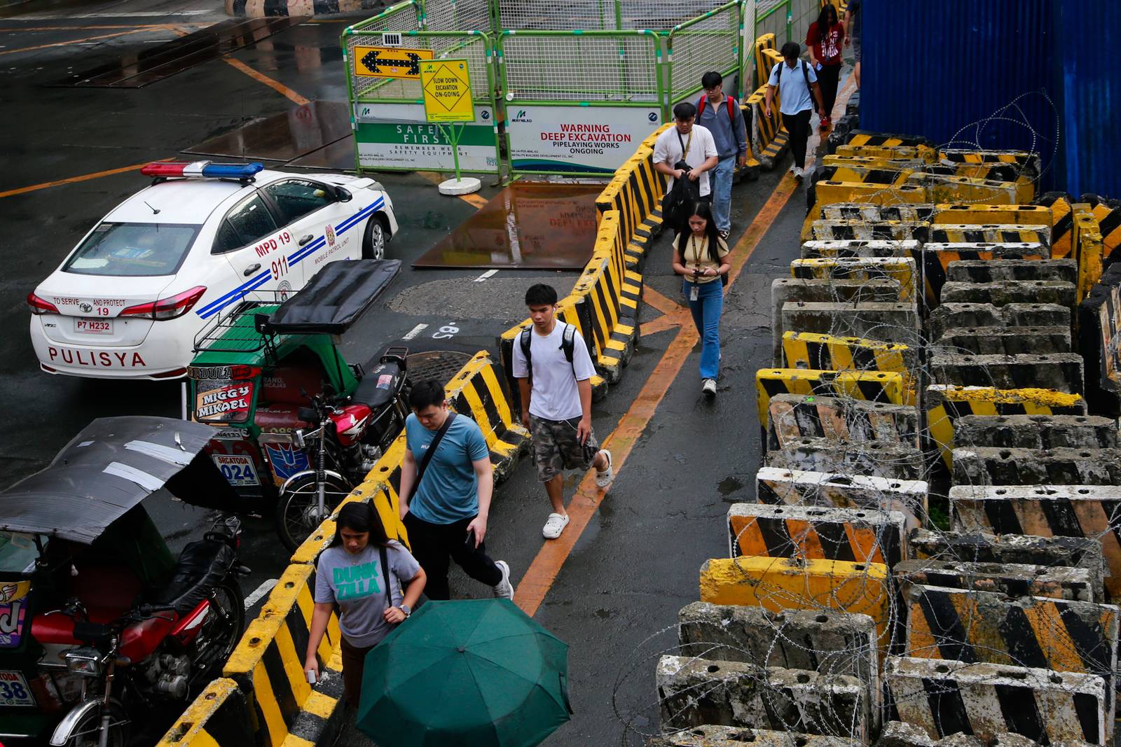 Concrete barriers, razor wire, and container vans block roads leading to the Malacañang Complex in Manila on 10 July 2026 as authorities tighten security ahead of an anti-corruption protest at Liwasang Bonifacio organized by an interfaith group.