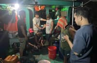 Operatives from the CIDG National Capital Region Field Unit inspect one of two confiscated tugboats used in an illegal ‘paihi ’ fuel-siphoning operation in Barangay Concepcion, Malabon City, at around 2:30 a.m. on Friday.