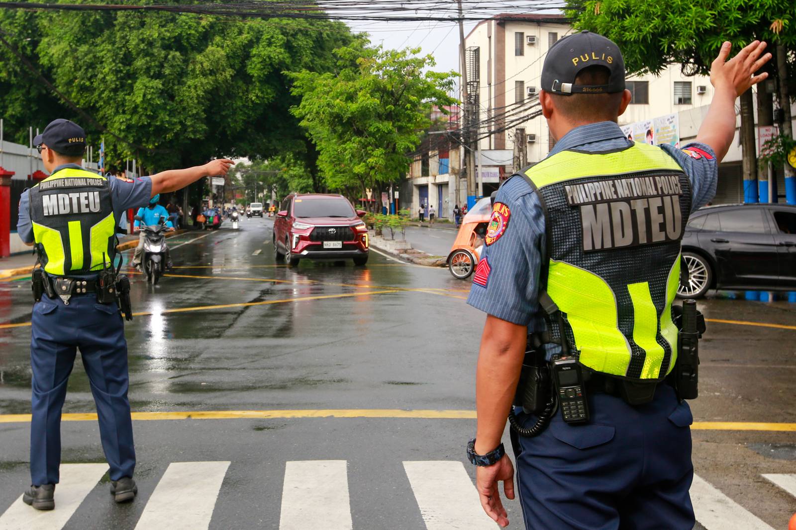 Concrete barriers, razor wire, and container vans block roads leading to the Malacañang Complex in Manila on 10 July 2026 as authorities tighten security ahead of an anti-corruption protest at Liwasang Bonifacio organized by an interfaith group.