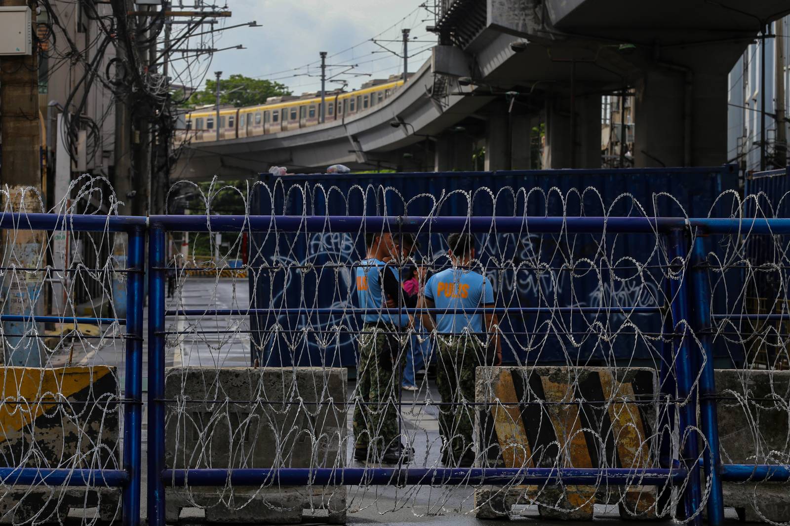 Concrete barriers, razor wire, and container vans block roads leading to the Malacañang Complex in Manila on 10 July 2026 as authorities tighten security ahead of an anti-corruption protest at Liwasang Bonifacio organized by an interfaith group.