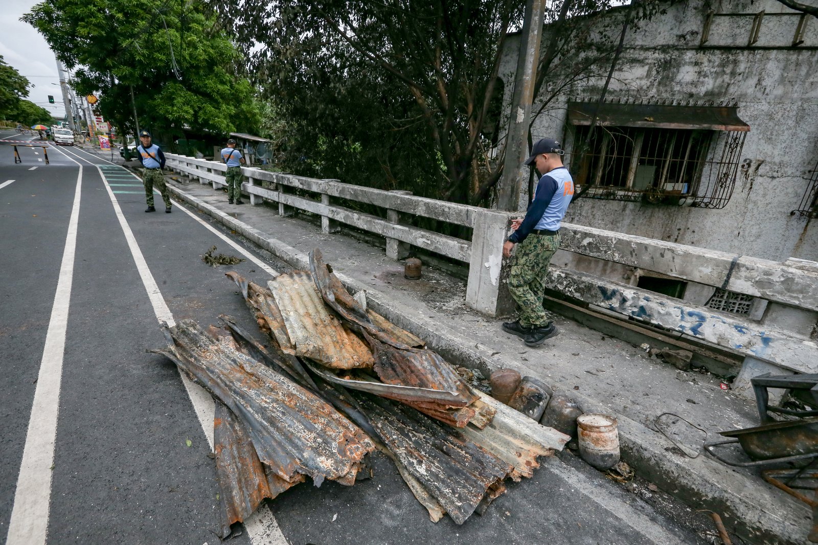 A fourth-alarm fire razed 46 houses beneath Culiat Bridge II along Congressional Avenue in Quezon City on Saturday night before it was declared out at 11:26 p.m. The Quezon City government said 38 families were affected, including residents of a nearby house. Authorities continue to assess the damage, with road closures in place as investigators examine the area, where damaged utility lines and a long crack on the bridge's asphalt surface were observed.