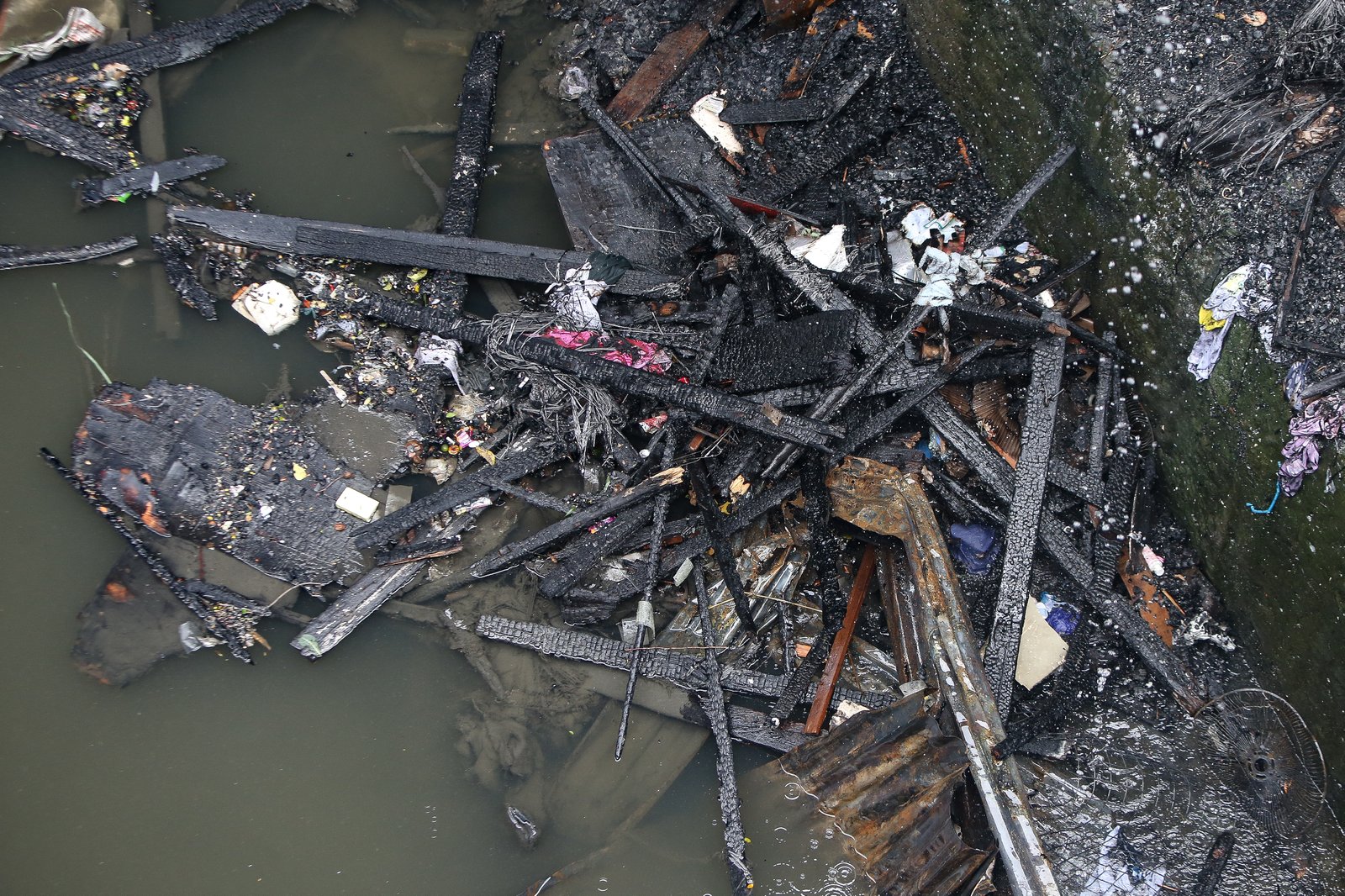 A fourth-alarm fire razed 46 houses beneath Culiat Bridge II along Congressional Avenue in Quezon City on Saturday night before it was declared out at 11:26 p.m. The Quezon City government said 38 families were affected, including residents of a nearby house. Authorities continue to assess the damage, with road closures in place as investigators examine the area, where damaged utility lines and a long crack on the bridge's asphalt surface were observed.