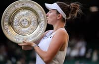 Linda Noskova of the Czech Republic savors her first Grand Slam crown following a 6-2, 5-7, 6-3 win over compatriot Karolina Muchova on Saturday at Wimbledon.