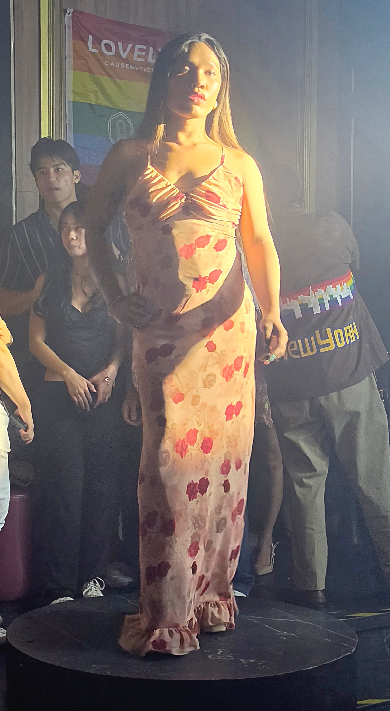 Dress enlivened by red floral accents, a ruched bodice and delicate ruffled edging at the hem.