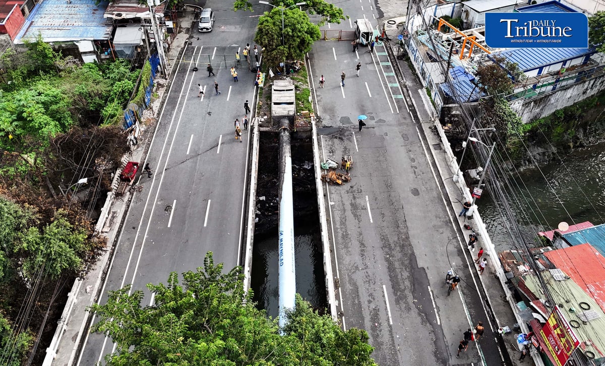(July 13 2026) The Congressional Avenue bridge in Barangay Bahay Toro on Monday July 13 2026, remains closed to vehicles to ensure the safety of motorists and residents passing through, After a 4th alarm fire hit the area on Saturday night July 11 2026. The bridge is deemed unsafe for any vehicle because parts of it have lifted due to the heat generated by the fire. Photo/Analy Labor