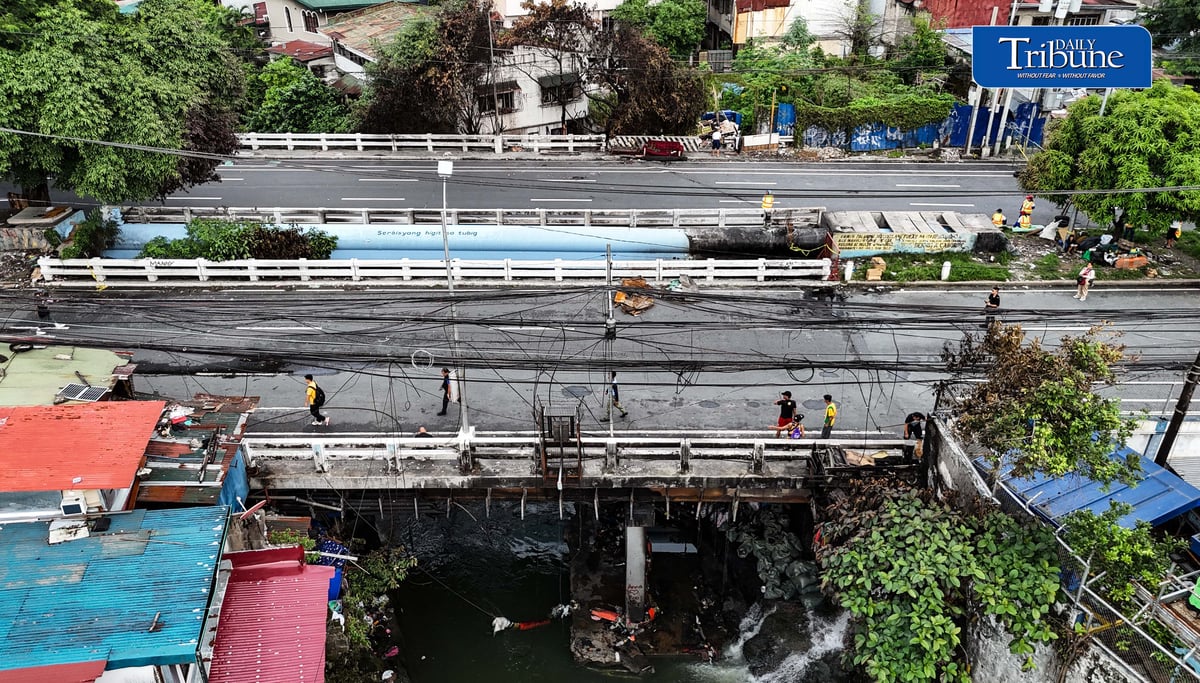 (July 13 2026) The Congressional Avenue bridge in Barangay Bahay Toro on Monday July 13 2026, remains closed to vehicles to ensure the safety of motorists and residents passing through, After a 4th alarm fire hit the area on Saturday night July 11 2026. The bridge is deemed unsafe for any vehicle because parts of it have lifted due to the heat generated by the fire. Photo/Analy Labor