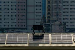 Construction workers place solar panels at Far Eastern University