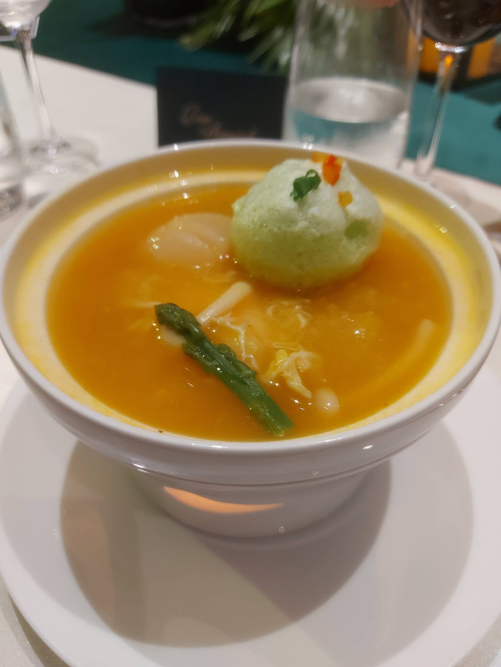 Signature Golden Broth with Crabmeat and Seafood with Green Egg White Foam.