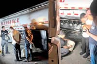 Authorities question the two suspects who were apprehended after they were caught smuggling illegally traded petroleum products at Barangay San Benito in Dinalupihan, Bataan.