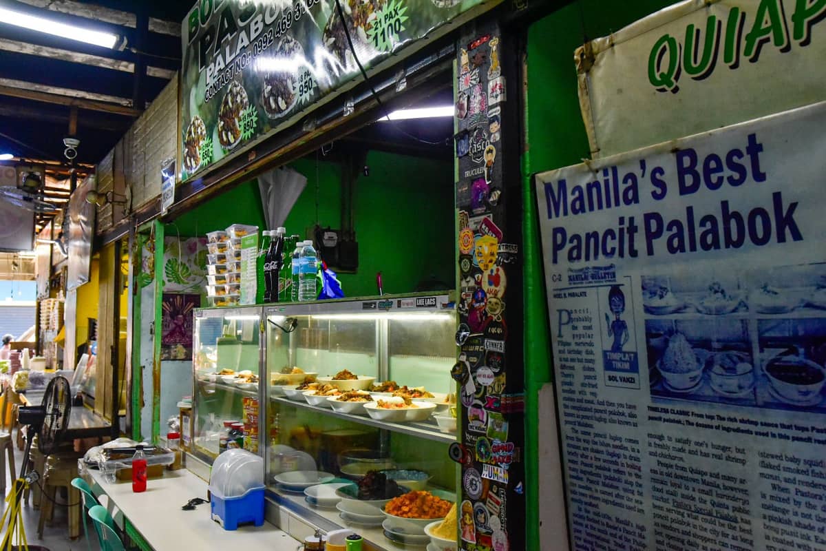 For 80 years, Pastora’s Palabok, also known as Boet and Mayer, has drawn diners from across different cities to Quiapo, Manila, for its signature pancit palabok.
The dish is coated in a rich, flavorful sauce mixed with shrimp and pork, and topped with tofu, chicharon bits, boiled egg, and squid. A regular serving costs ₱90, while the ₱120 serving comes with additional toppings. | Zedrich Xylak Madrid