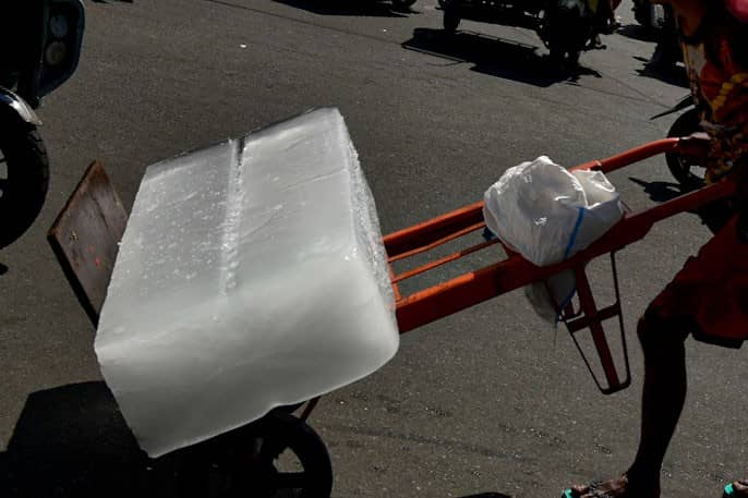 A man is seen pushing a cart carrying a block of ice in Quiapo, Manila, on 18 July.
Workers of the country rely on physically demanding work to earn a living amid limited access to stable and secure employment. l Zedrich Xylak Madrid