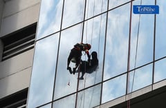 Workers cleaning window