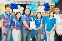 ERIK C. delos Santos (4th from left), Corporate Guarantee business development/branch head, presents the Certificate of Insurance Coverage to Highway Hills Integrated School elementary assistant principal Sonia Daganio.