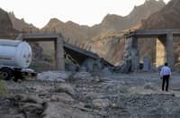 A HEAVILY-DAMAGED bridge which was hit by a United States strike is pictured along the road connecting Roudan and Bandar Abbas in southern Iran on 18 July 2026.