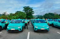 DRIVERS stand beside Green SM electric vehicles as the company continues to invest in its workforce and service standards across its markets.