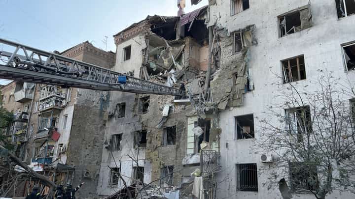 A local resident reacts in front of a partially destroyed residential building following a Russian strike in Zaporizhzhia amid the Russian invasion of Ukraine.