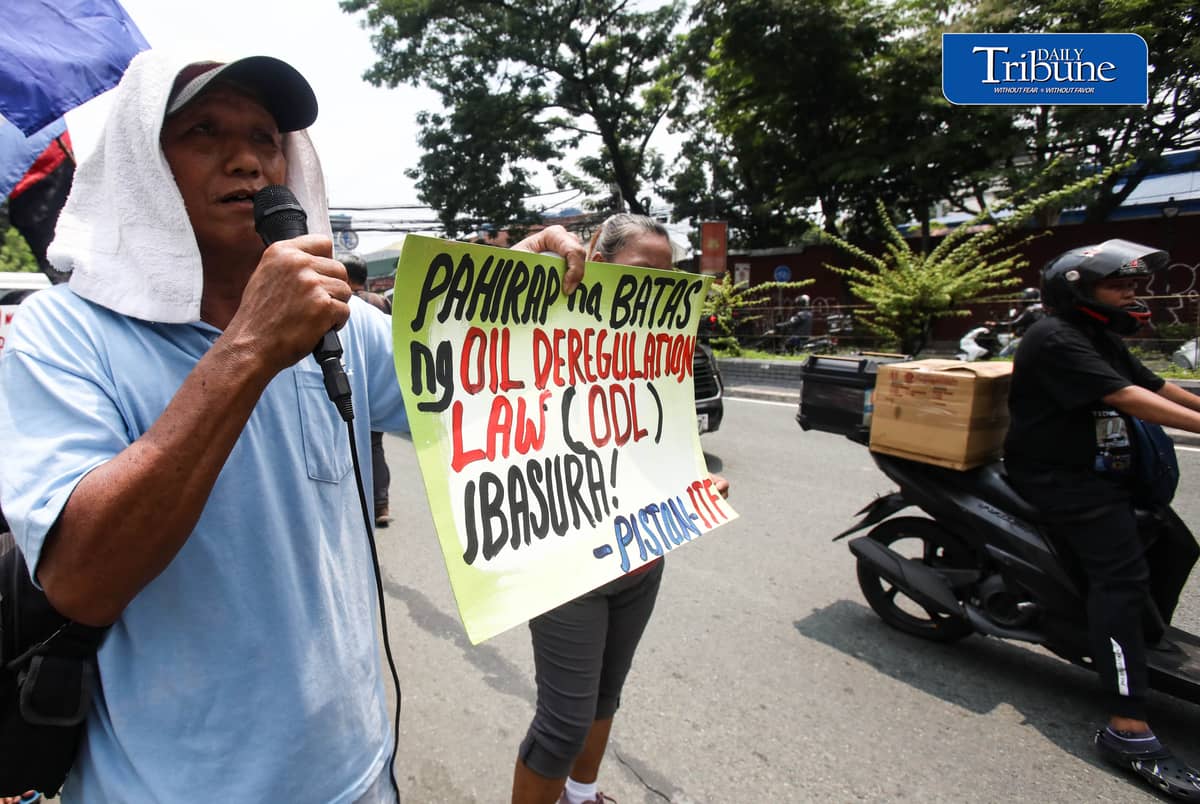 OIL PRICE PROTEST
Members of transport group Piston stage a protest outside a Petron gas station along East Avenue in Quezon City on Tuesday, July 21, 2026, opposing the latest round of big-time fuel price hikes. Photo by Analy Labor