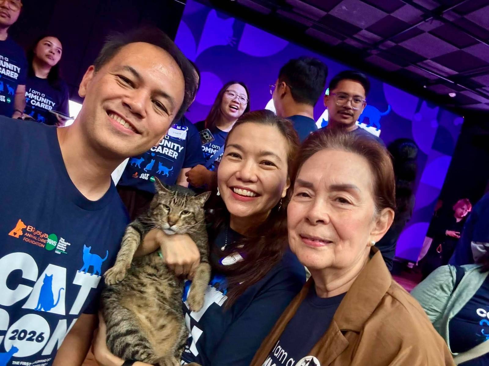 Just adopted: Anna Cabrera gives a new home to Diet her newly-adopted  ‘chonky’ cat. She is with PAWS director Rich Ilustre and Nancy Cu-Unjieng of CARA.