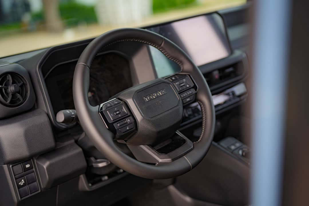FUNCTIONAL controls and a driver-focused layout shape the cabin of the Land Cruiser FJ TX.