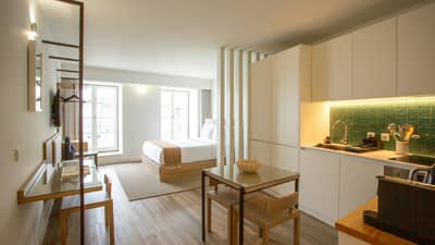 Modern studio apartment features a smart, open-concept design that cleverly divides the living, dining and sleeping areas.