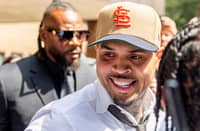 US singer Chris Brown departs after attending a hearing at Southwark Crown Court in London on July 24, 2026. Brown on July 24, 2026, pleaded guilty to a public order offence following an alleged brawl at a London nightclub in 2023. "Guilty," replied Brown, 37, dressed in a beige suit and dark tie, after the charge of affray was put to him as he stood in the dock at Southwark Crown Court in London.