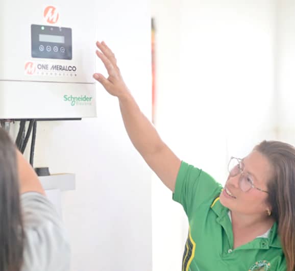 Better healthcare for all. With solar technology powering their health station, barangay health workers take charge of the new equipment, learning best practices for its daily use and long-term upkeep.