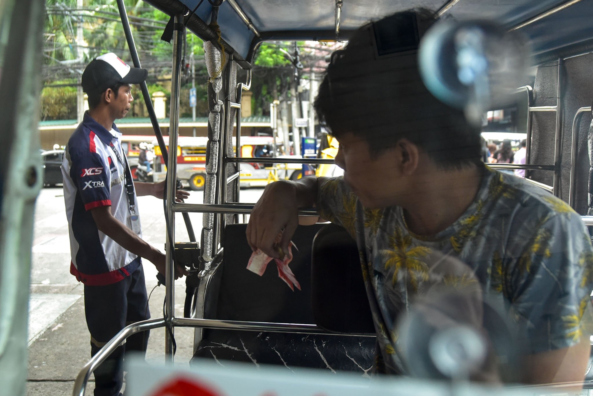 Motorists fill their tanks with gas before the looming oil price hike