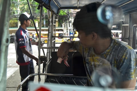 Motorists fill their tanks with gas before the looming oil price hike
