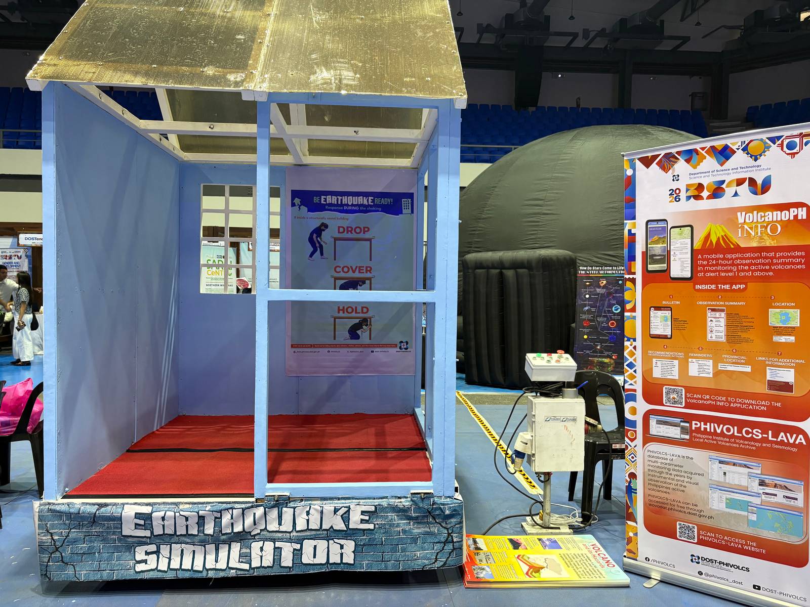 Participants experience simulated seismic movement inside an earthquake simulator platform designed to raise public awareness and test emergency readiness protocols during disaster drills.