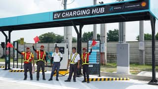 CREW members stand beside the new DC fast chargers at Shell Mexico NLEX, one of eight charging hubs now operating nationwide.