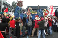 THOUSANDS of demonstrators march along Commonwealth Avenue in Quezon City during the 'Martsa ng Bayan' protest held alongside President Ferdinand Marcos Jr.’s fifth State of the Nation Address on Monday.