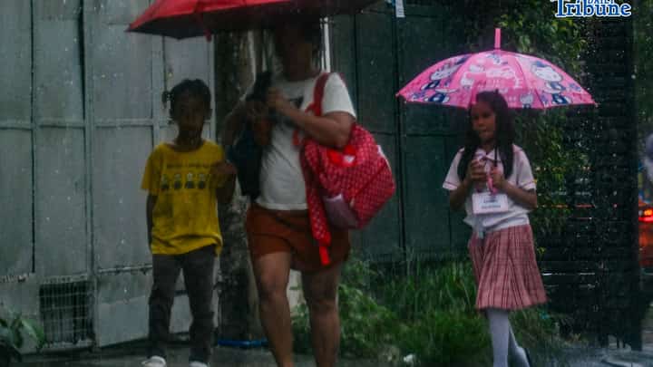 Parents fetch their children from school as continuous rain drenches the city on Wednesday, July 29, 2026. PHOTO BY YUMMIE DINGDING