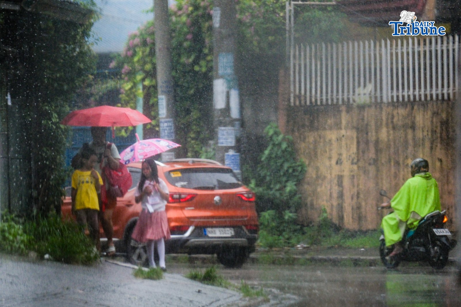 Parents fetch their children from school as continuous rain drenches the city on Wednesday, July 29, 2026. PHOTO BY YUMMIE DINGDING