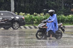Pedestrians seen with raincoats and umbrellas due to heavy rainfall Manila