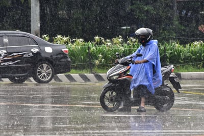 Pedestrians seen with raincoats and umbrellas due to heavy rainfall Manila