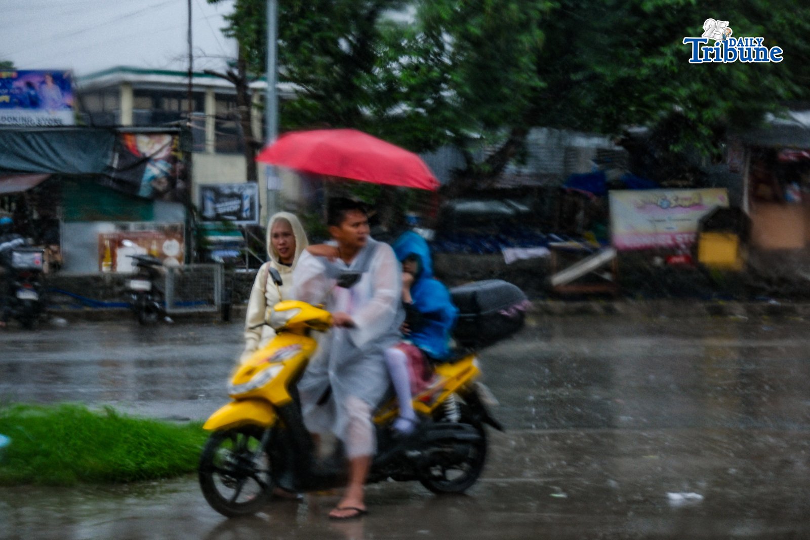 Parents fetch their children from school as continuous rain drenches the city on Wednesday, July 29, 2026. PHOTO BY YUMMIE DINGDING