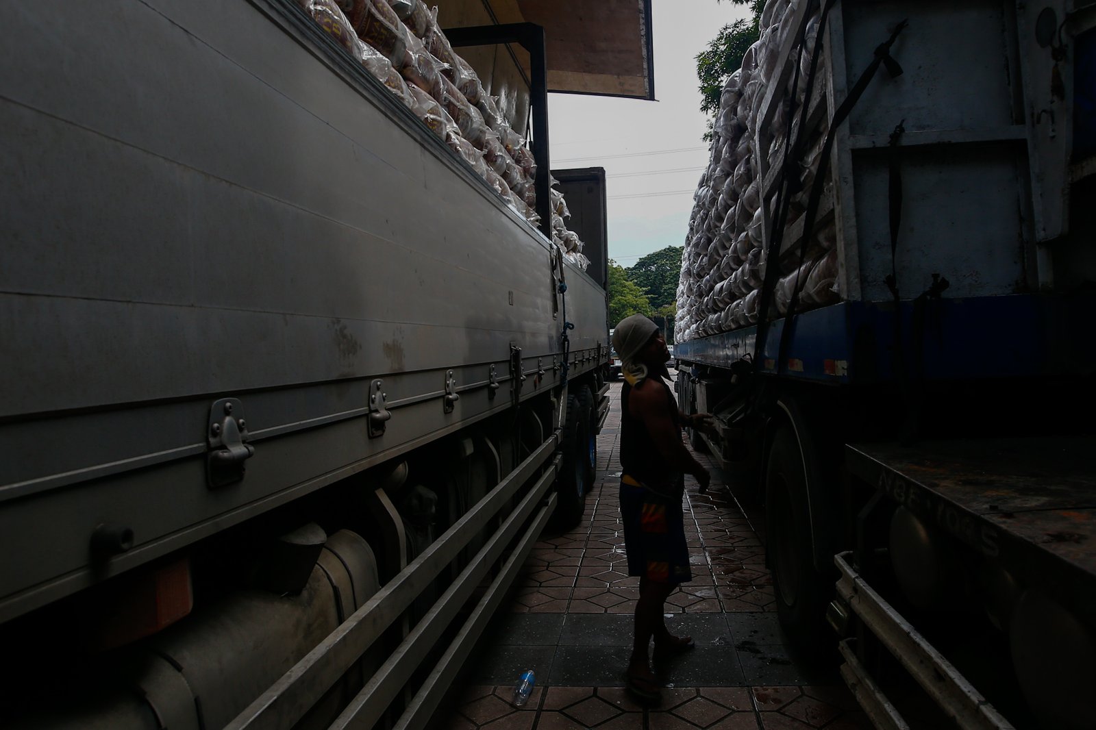 Workers unload sacks of rice for the third tranche of the "Biyayang Bigas para sa Maynila" program at the Kartilya ng Katipunan on July 30, 2026. The Marcos administration's initiative provides subsidized rice to workers in the City of Manila and, according to the administration, aims to help families cope with ongoing economic pressures while supporting local rice farmers.