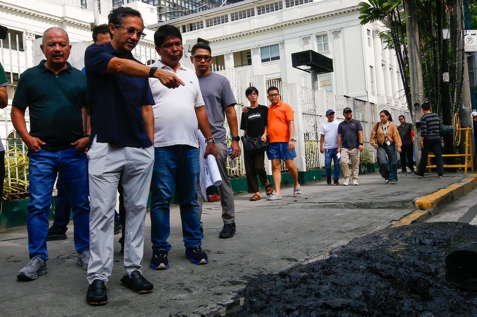 Department of Public Works and Highways personnel remove silt and debris from a drainage system along Taft Avenue in Ermita, Manila on the morning of 31 July 2026 as Secretary Vince Dizon inspects the proposed drainage rehabilitation project. The inspection is part of a series of site visits to ensure that critical flood control projects are progressing to help protect communities in flood-prone areas.