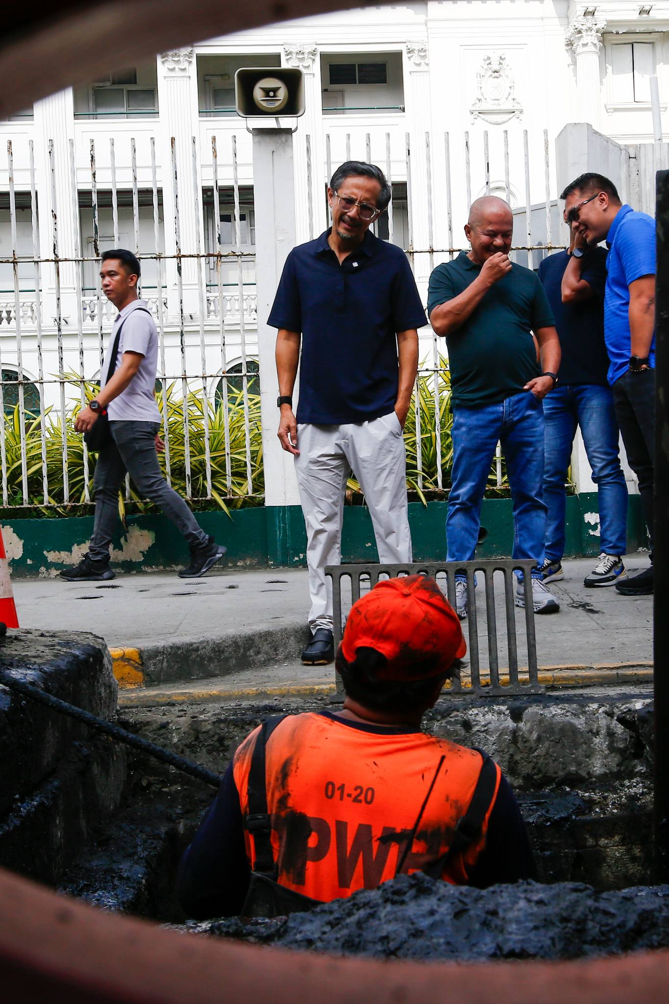 Department of Public Works and Highways personnel remove silt and debris from a drainage system along Taft Avenue in Ermita, Manila on the morning of 31 July 2026 as Secretary Vince Dizon inspects the proposed drainage rehabilitation project. The inspection is part of a series of site visits to ensure that critical flood control projects are progressing to help protect communities in flood-prone areas.