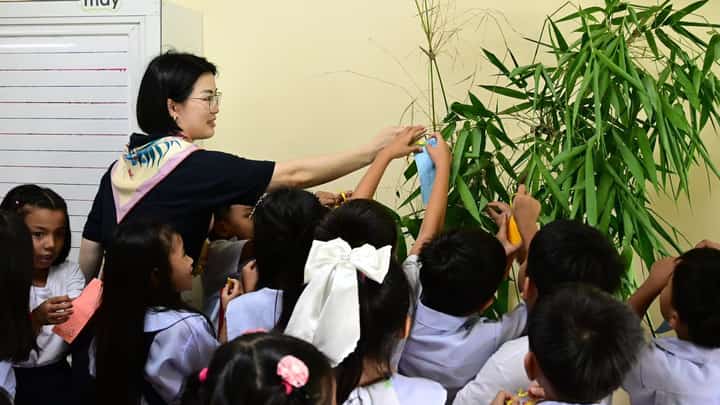 Wishes hung from bamboo. Beside it stood six new classrooms built to replace a school worn down by time.