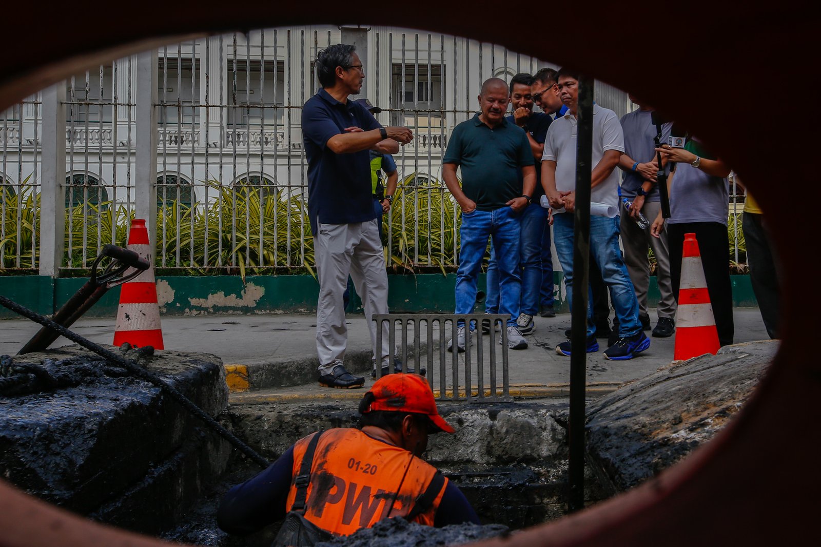 Department of Public Works and Highways personnel remove silt and debris from a drainage system along Taft Avenue in Ermita, Manila on the morning of 31 July 2026 as Secretary Vince Dizon inspects the proposed drainage rehabilitation project. The inspection is part of a series of site visits to ensure that critical flood control projects are progressing to help protect communities in flood-prone areas.