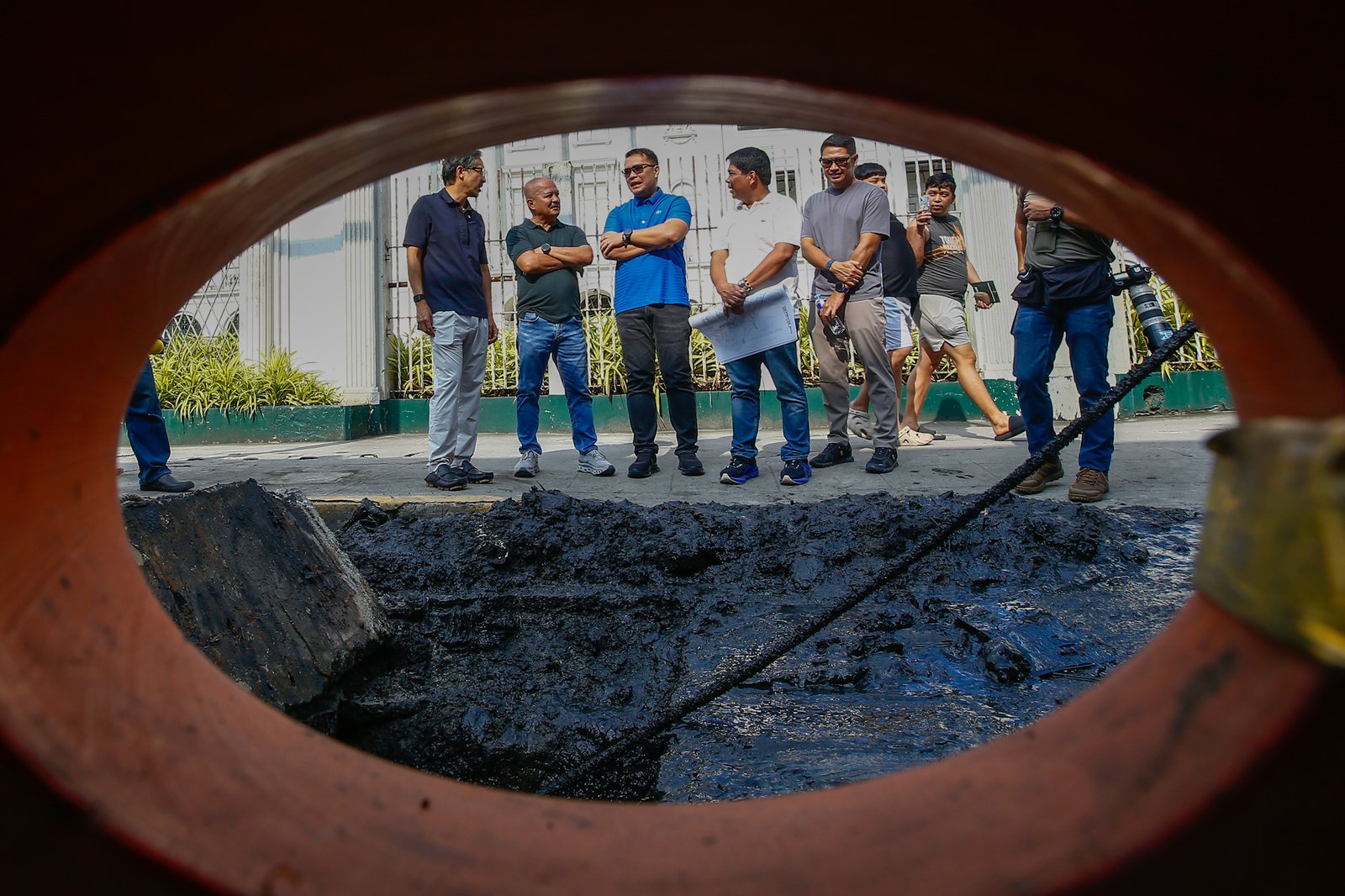 Department of Public Works and Highways personnel remove silt and debris from a drainage system along Taft Avenue in Ermita, Manila on the morning of 31 July 2026 as Secretary Vince Dizon inspects the proposed drainage rehabilitation project. The inspection is part of a series of site visits to ensure that critical flood control projects are progressing to help protect communities in flood-prone areas.