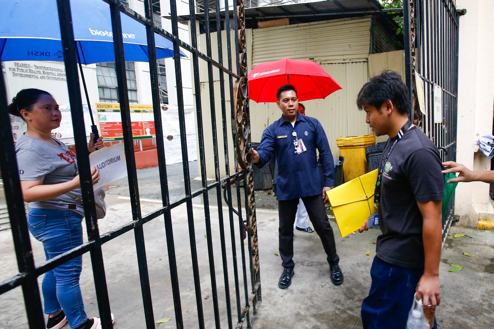 Undeterred by sudden rain showers, aspiring Iskolar ng Bayan queue to take the University of the Philippines College Admission Test (UPCAT) at UP Manila along Pedro Gil Street on 2 August 2026.