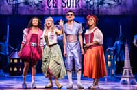 A scene from the musical '& Juliet' featuring characters in stylized Elizabethan costumes.