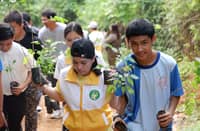 Volunteers, students and community members carry narra seedlings for planting during the ‘50K Trees: Green Shields Save Lives’ reforestation activity in Sitio Parawagan, Barangay San Rafael, Rodriguez, Rizal.