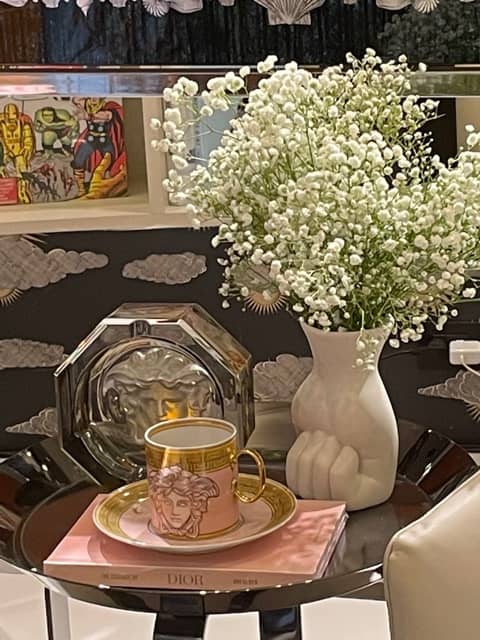 Decorate with some really nice accessories  like a mug, saucer, vase on a table.