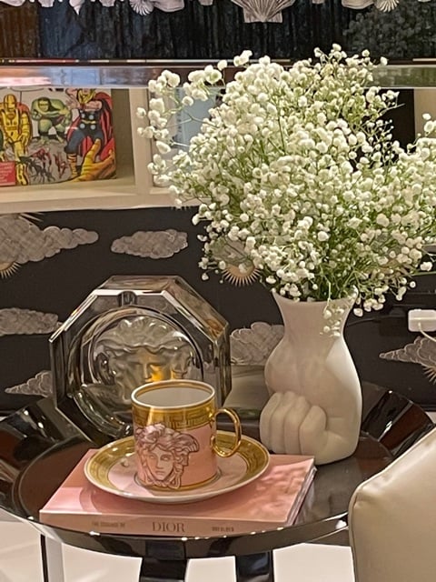 Decorate with some really nice accessories  like a mug, saucer, vase on a table.