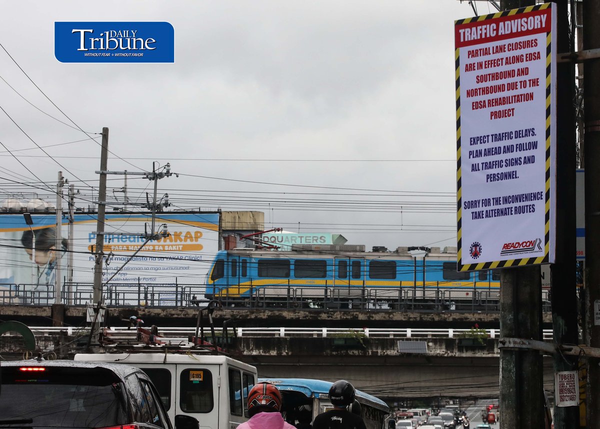 (August 06 2026) An advisory tarpaulins from the Department of Public Works and Highways (DPWH) to expect heavy traffic due to the EDSA Rehabilitation Project seen hang along Kamuning Road corner Edsa in Quezon City on Thursday august 6 2026, as motorists passes by and the MTR3 Dalian train, The DPWH plans to conduct partial lane closures along the southbound lane of EDSA from Monumento to Guadalupe, and advises the public to take alternative routes. Photo/Analy Labor