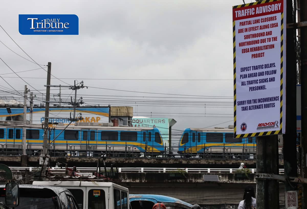 (August 06 2026) An advisory tarpaulins from the Department of Public Works and Highways (DPWH) to expect heavy traffic due to the EDSA Rehabilitation Project seen hang along Kamuning Road corner Edsa in Quezon City on Thursday august 6 2026, as motorists passes by and the MTR3 Dalian train, The DPWH plans to conduct partial lane closures along the southbound lane of EDSA from Monumento to Guadalupe, and advises the public to take alternative routes. Photo/Analy Labor